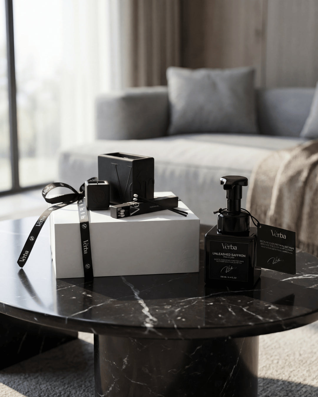 Black Vérba candle and gift box on a dark marble coffee table in a modern living room — why expensive candles feel different