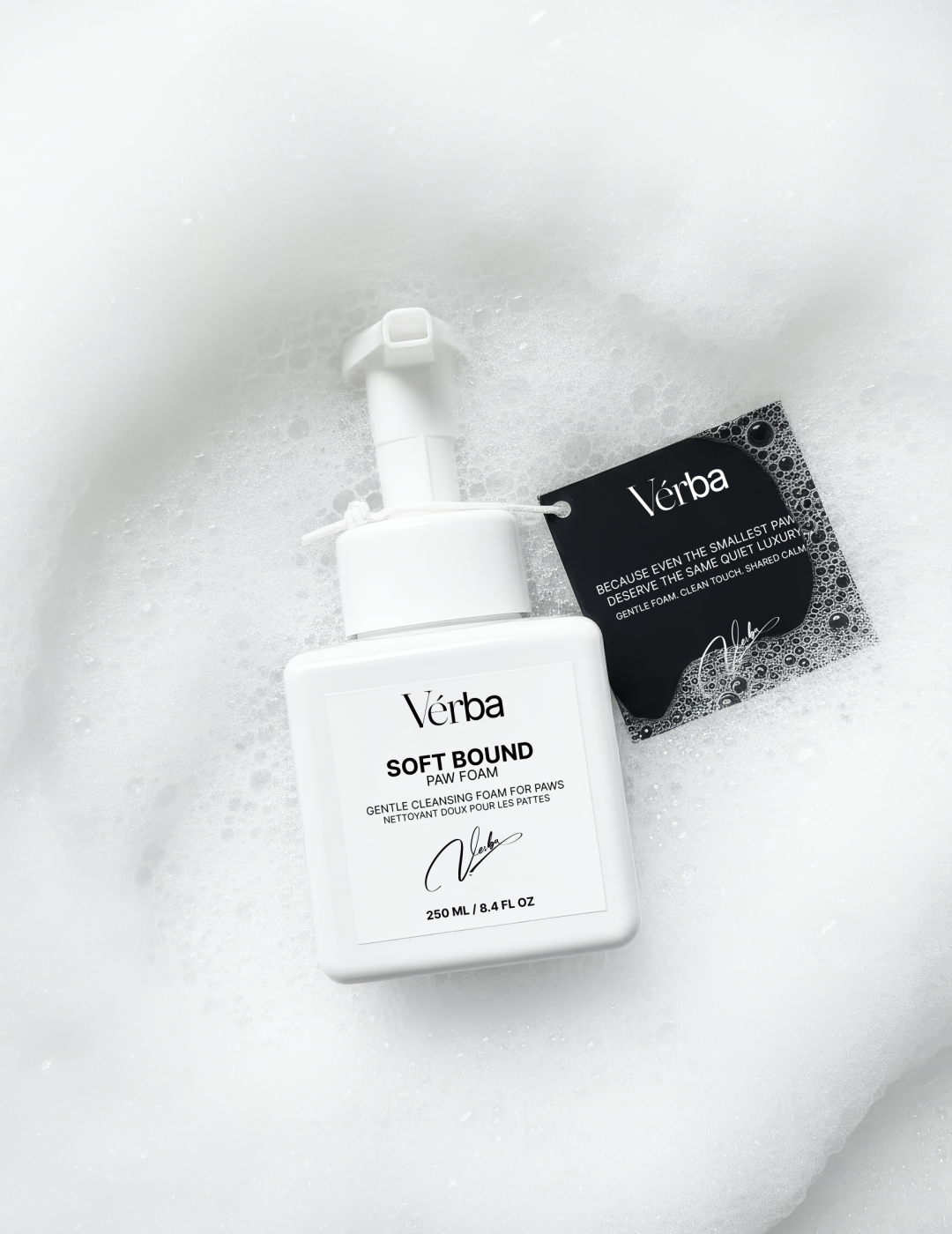 Verba Soft Bound Perfumed Paw Foam white bottle with black tag lying on white foam background