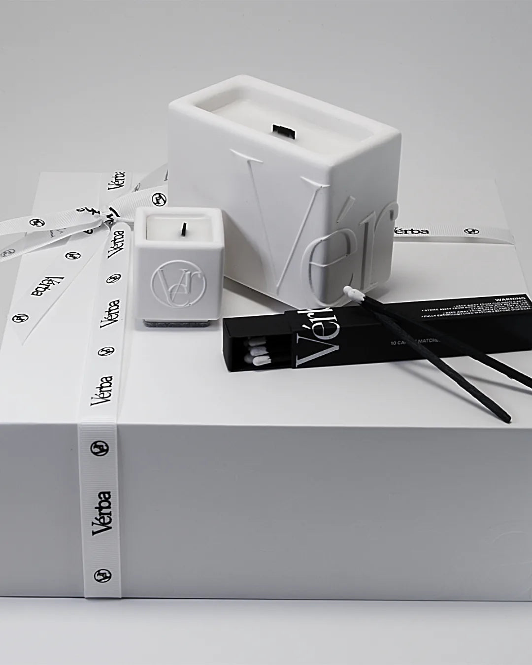 White Vérba luxury candle gift set — sculpted candle, mini candle and matches tied with branded ribbon