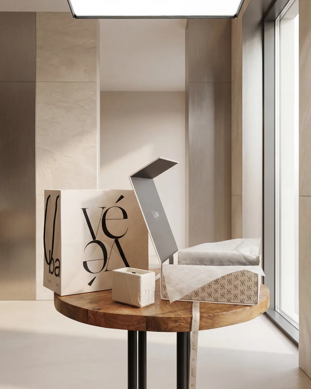 Vérba gift bag and open gift box with a white candle on a wooden side table — a hostess gift