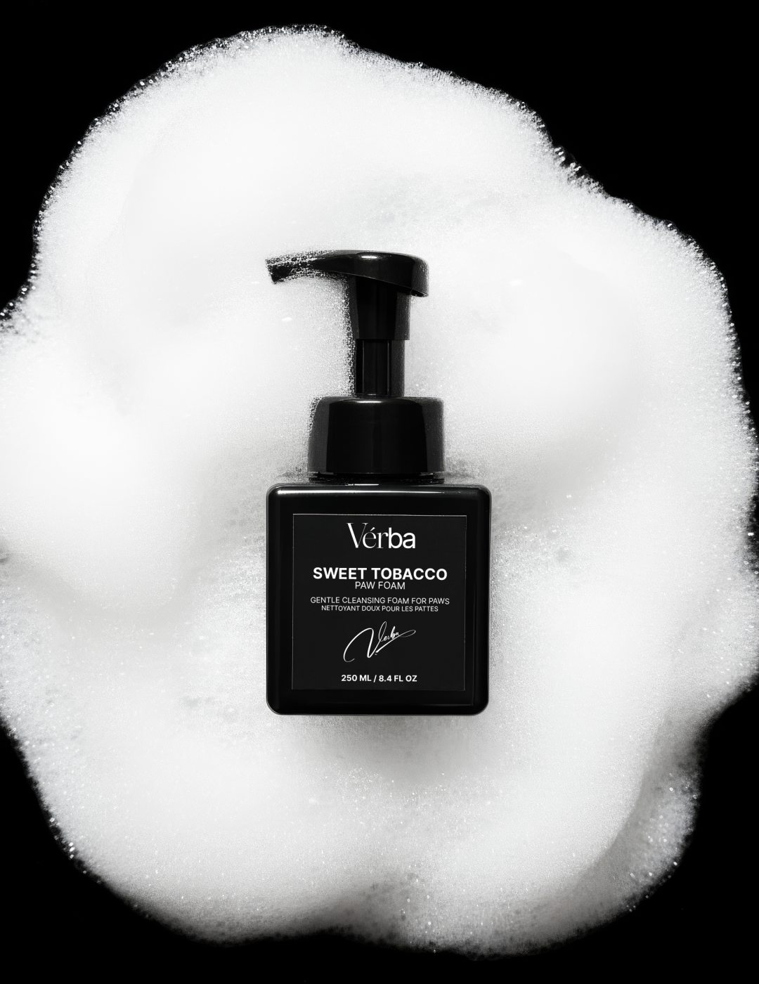 Verba Sweet Tobacco Perfumed Paw Foam black bottle surrounded by white foam on black background