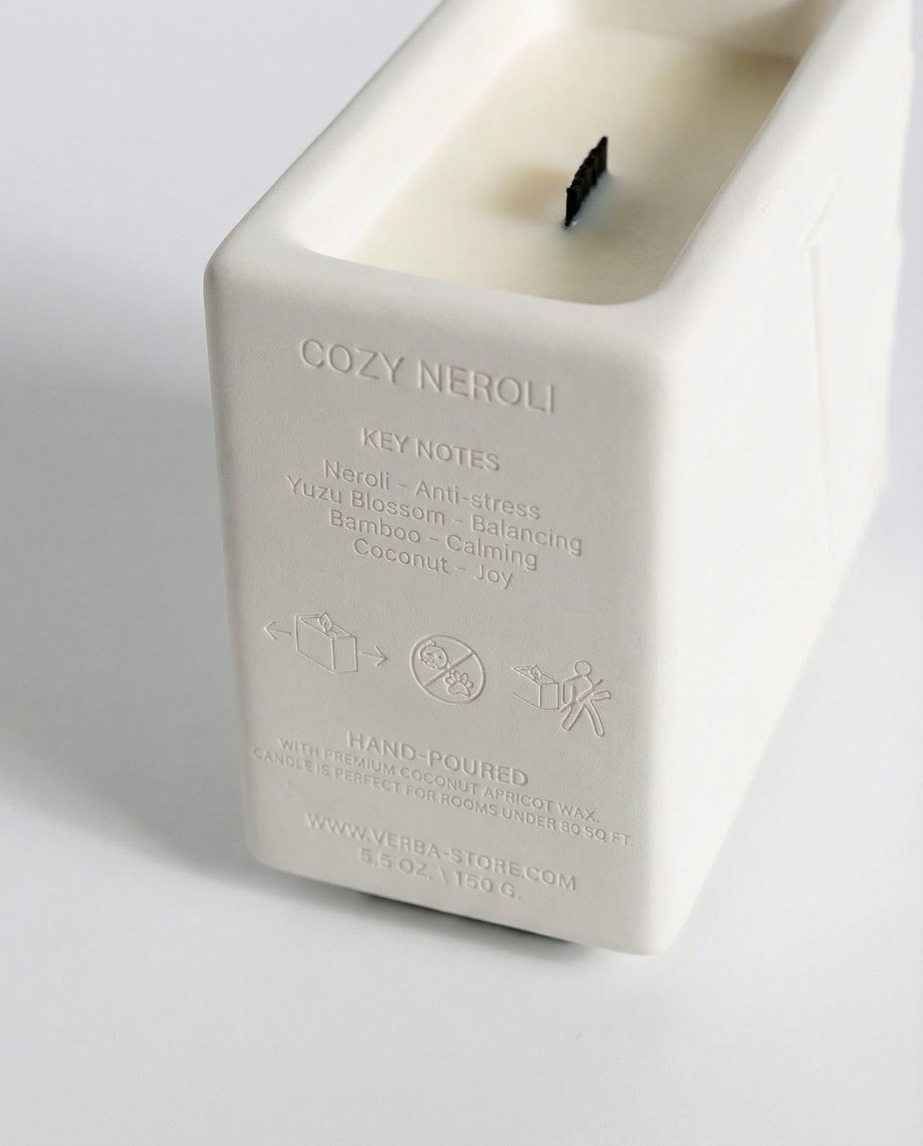 Close up of Hand-poured white collection Cozy neroli niche scent premium woodwick candle with premium coconut apricot wax – Verba 
