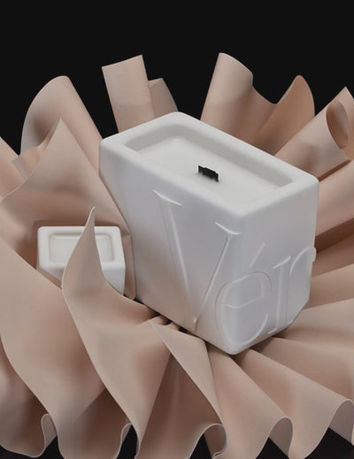 White Verba candles surrounded by soft folds of beige leather — Soft Bound fragrance video.