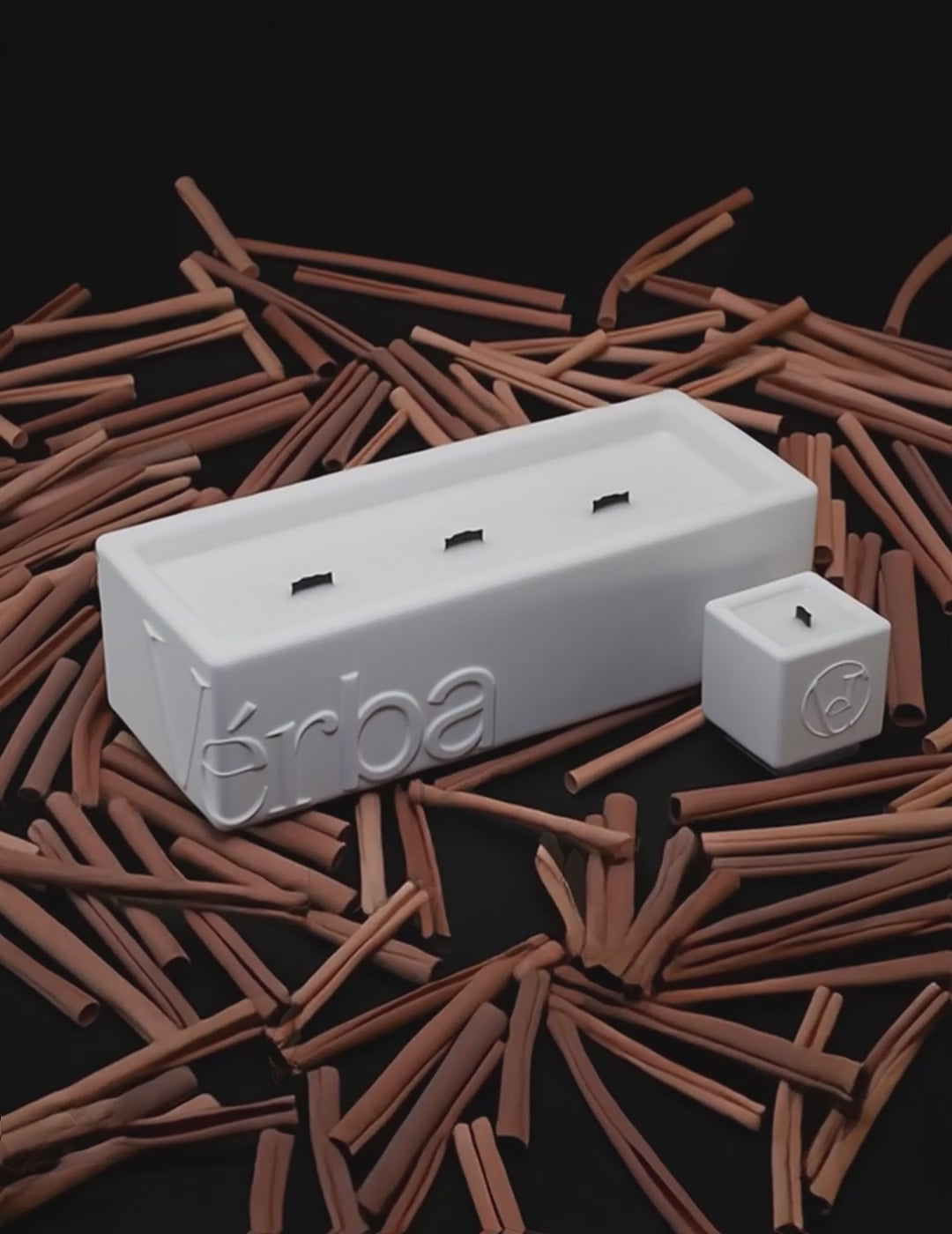 Large white Verba candle surrounded by cinnamon sticks — Cinnamon Hug fragrance video