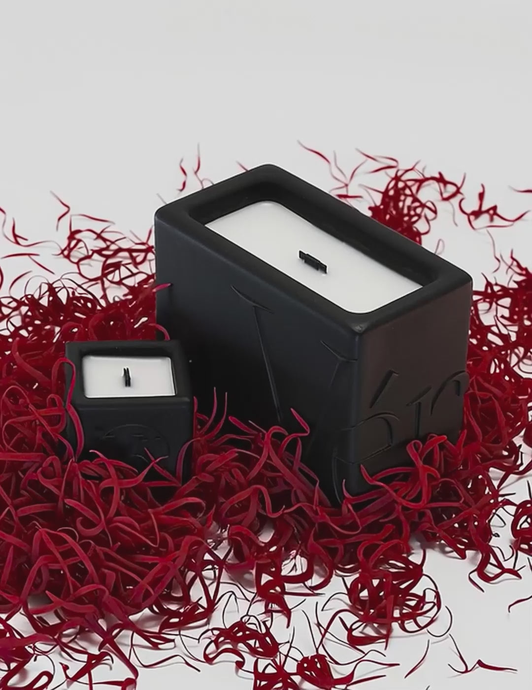 Black Verba candles surrounded by vivid red saffron threads — Unleashed Saffron fragrance video.