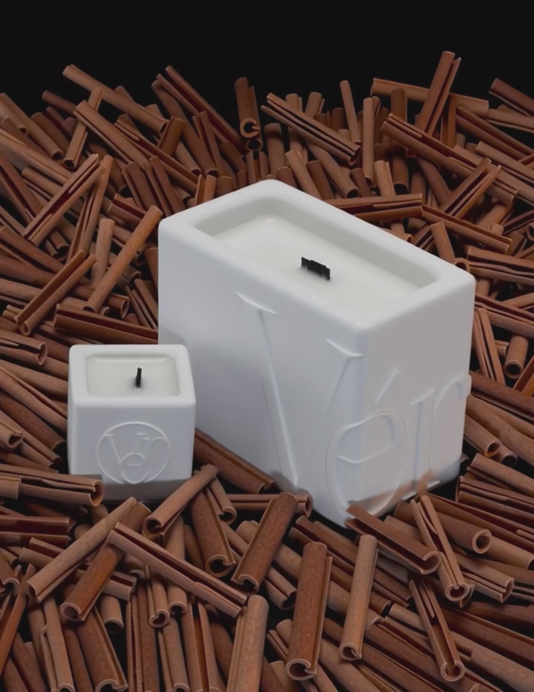 Luxury white Verba candle surrounded by moving cinnamon sticks — Cinnamon Hug fragrance video.