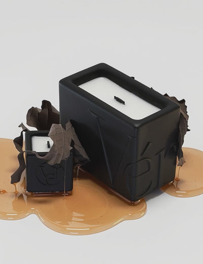 Black Verba candles surrounded by tobacco leaves and golden caramel — Sweet Tobacco fragrance video.