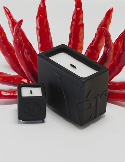 Black Verba candles surrounded by red chili peppers — Oud Péché fragrance video.