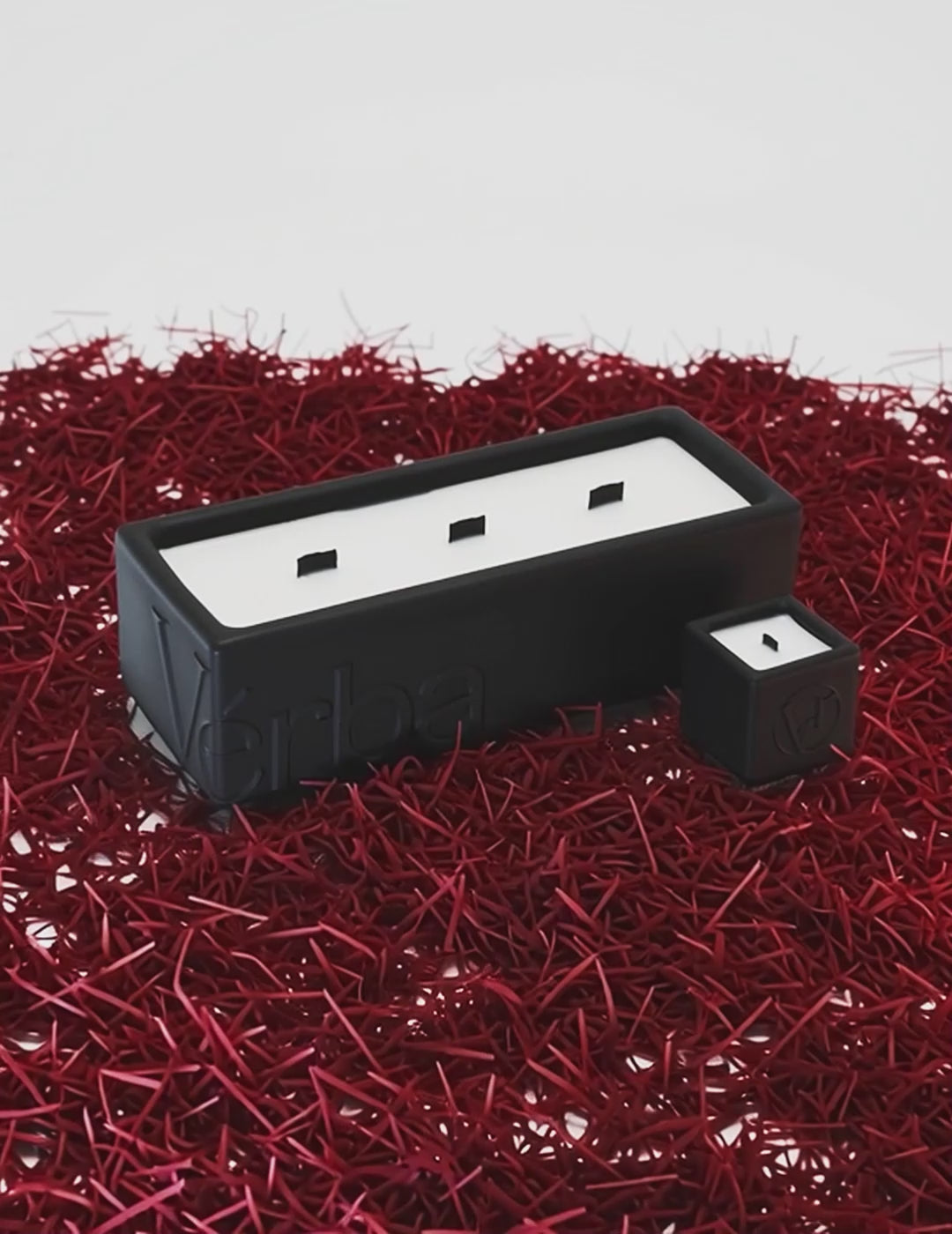 Large black Verba candle placed on vibrant red saffron threads — Unleashed Saffron fragrance video.
